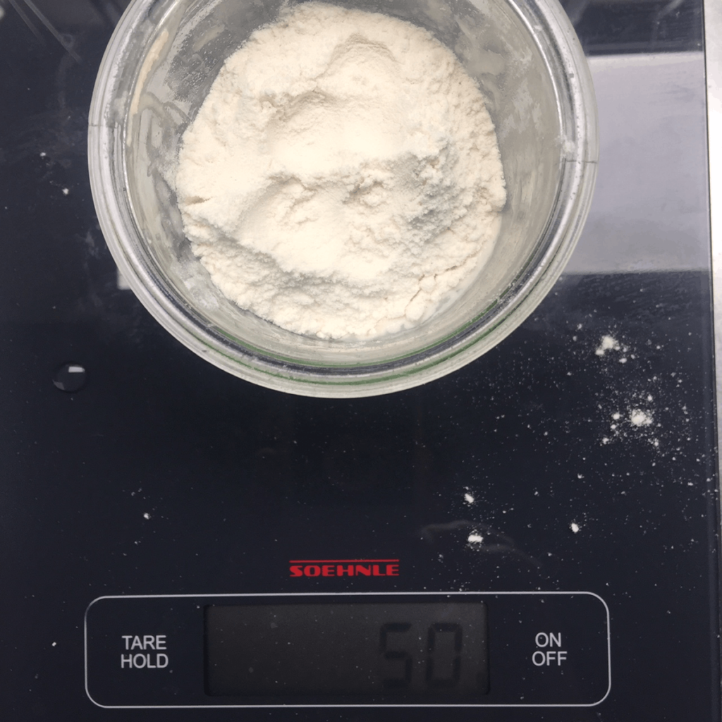 Starter with fresh flour on a digital scale