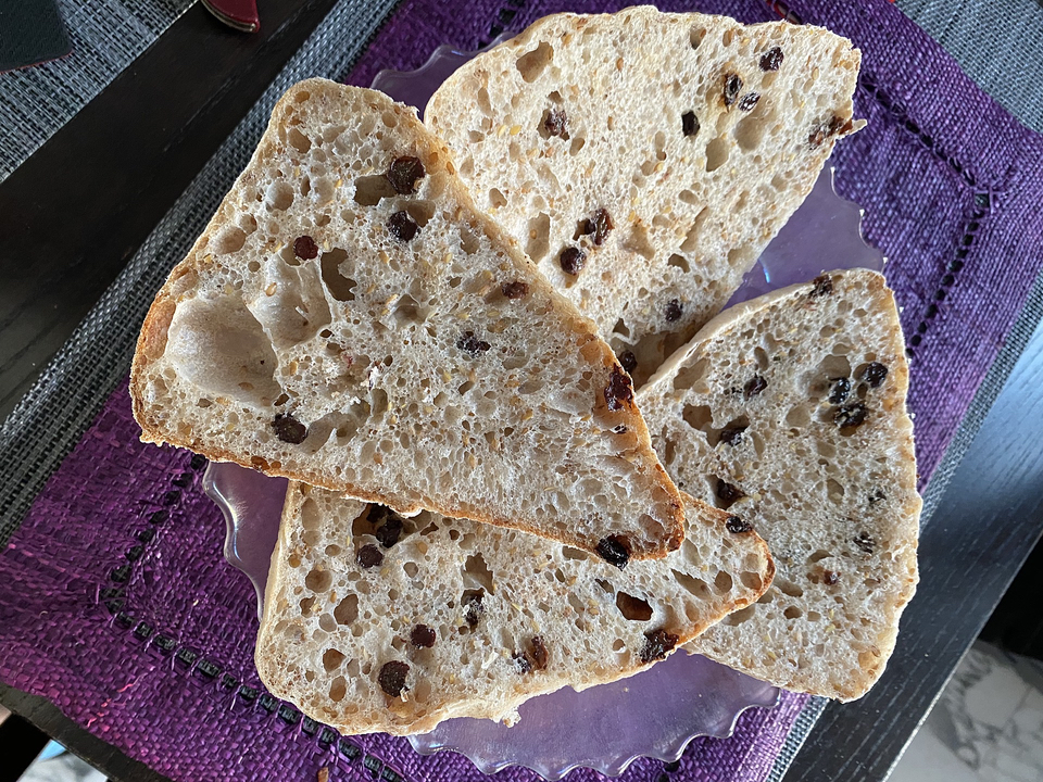 Little loaves sliced to show open crumb structure.